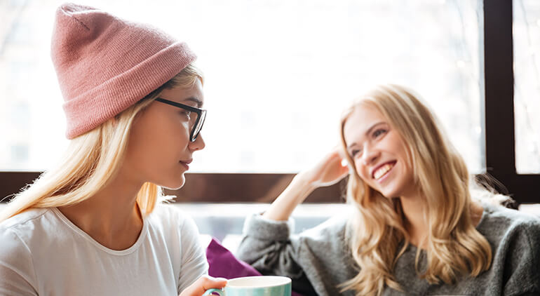 Two girls talking and smiling